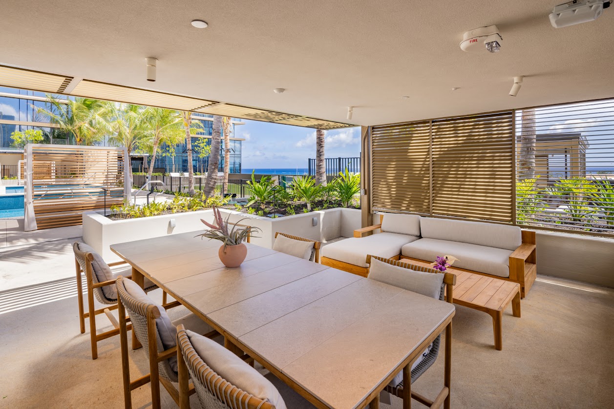 A modern dining room with a wooden table and chairs.